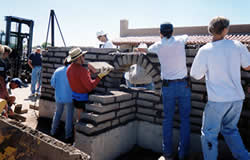 Students at the Spring's Tucson Class work on an adobe wall at Old Pueblo Adobe Co, Tucson, AZ