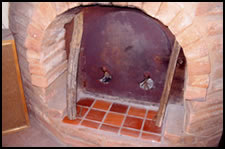 A view of the Grubka's firebox steel door with typical wood fuel of small diameter.
